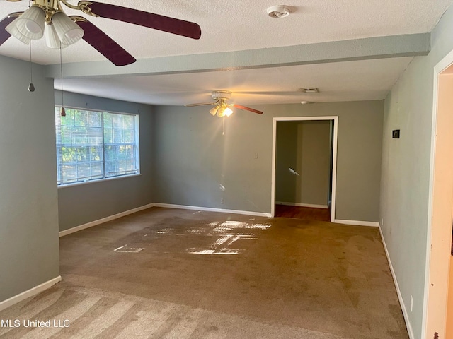 carpeted spare room featuring a textured ceiling and ceiling fan