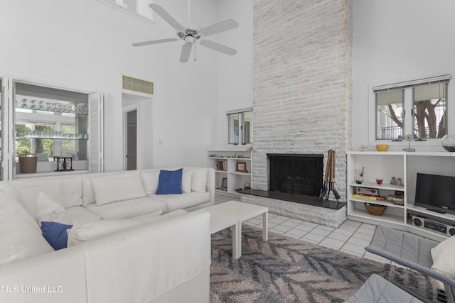11 Bayou Pl, Gulfport, MS 39503 - tiled living area featuring a towering ceiling, ceiling fan, and a fireplace