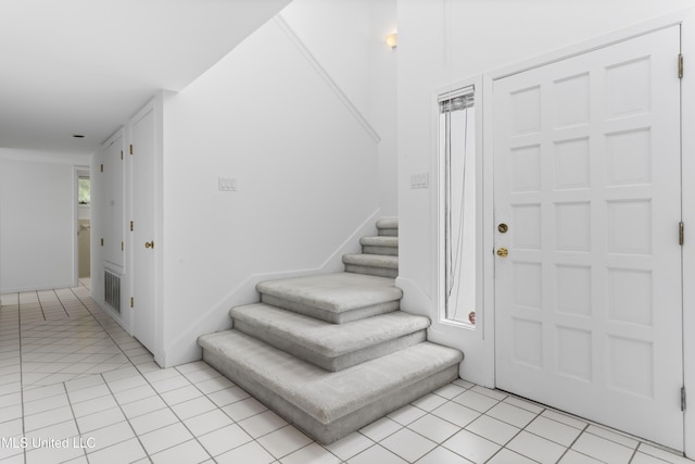 11 Bayou Pl, Gulfport, MS 39503 - entrance foyer with light tile patterned floors and stairs