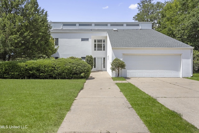11 Bayou Pl, Gulfport, MS 39503 - mid-century inspired home featuring concrete driveway, a front yard, stucco siding, roof with shingles, and a garage