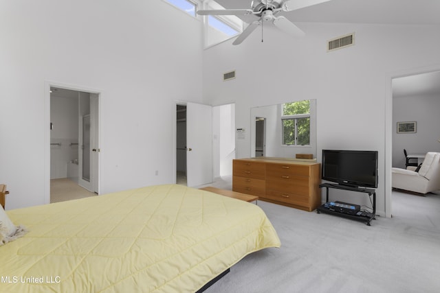 11 Bayou Pl, Gulfport, MS 39503 - bedroom with light carpet, a towering ceiling, a walk in closet, connected bathroom, and a closet