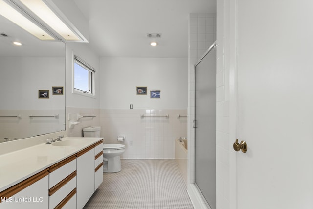 11 Bayou Pl, Gulfport, MS 39503 - bathroom with tile walls, vanity, toilet, a tub to relax in, and a shower
