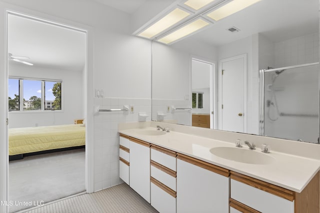 11 Bayou Pl, Gulfport, MS 39503 - ensuite bathroom with double vanity, a shower stall, and tile patterned flooring