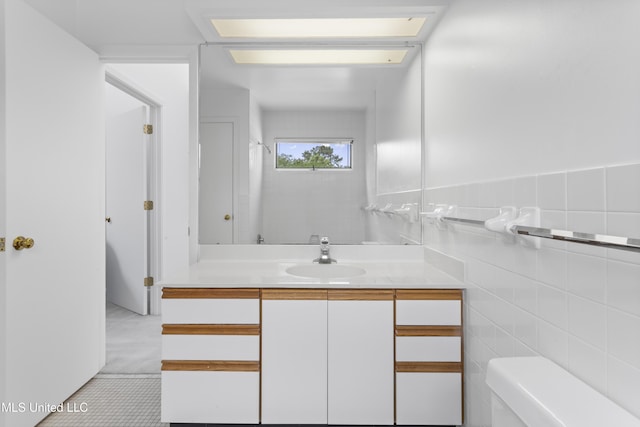 11 Bayou Pl, Gulfport, MS 39503 - bathroom with vanity, toilet, tile patterned floors, and tile walls
