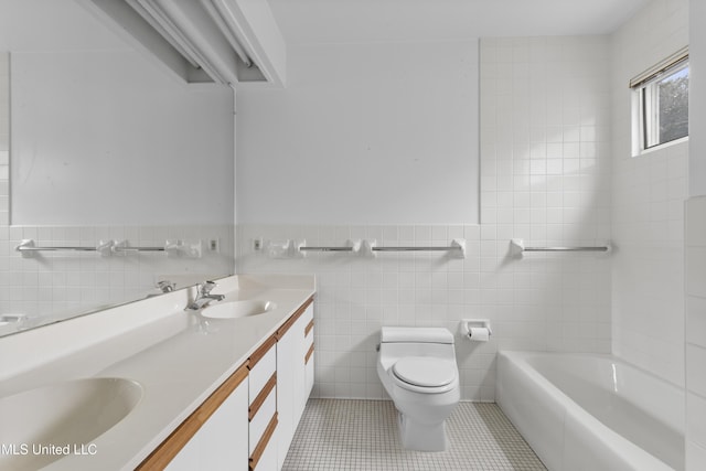 11 Bayou Pl, Gulfport, MS 39503 - full bath with tile walls, toilet, double vanity, tile patterned flooring, and a wainscoted wall