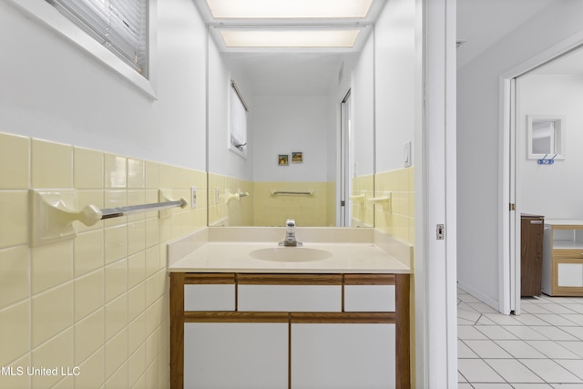 11 Bayou Pl, Gulfport, MS 39503 - bathroom featuring vanity, tile patterned flooring, tile walls, and a wainscoted wall