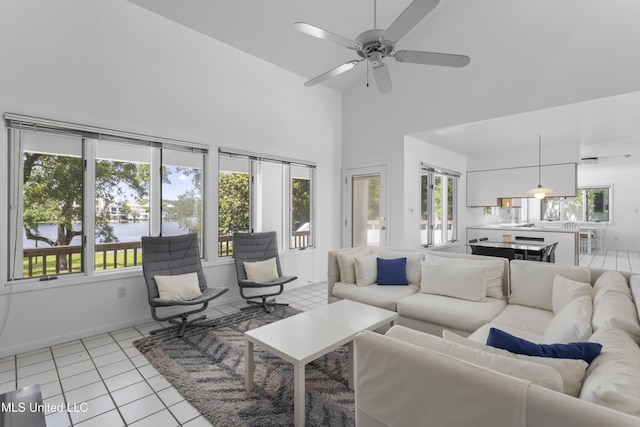 11 Bayou Pl, Gulfport, MS 39503 - living room with high vaulted ceiling, light tile patterned flooring, a ceiling fan, a water view, and baseboards