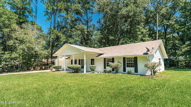 ranch-style home with a front yard and covered porch