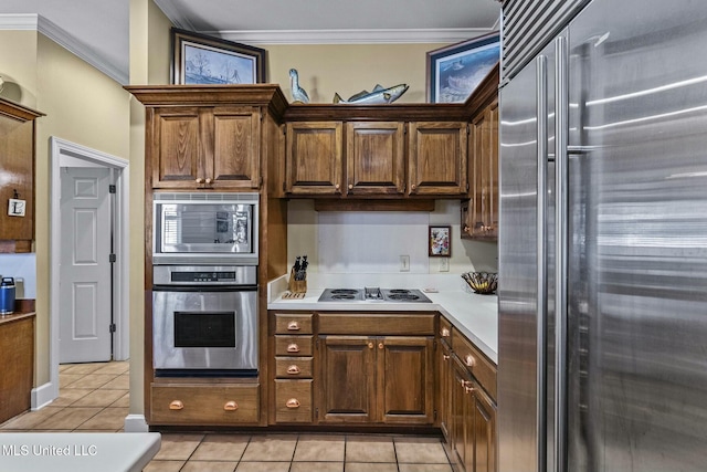 kitchen featuring crown molding, light tile patterned floors, and stainless steel appliances