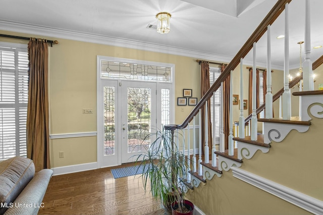 entrance foyer with hardwood / wood-style flooring and crown molding