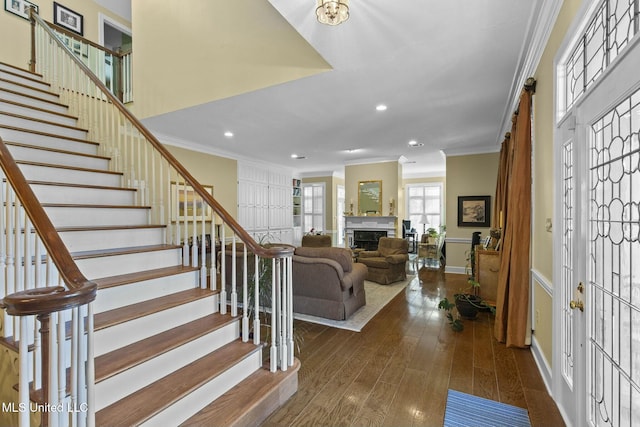 foyer with crown molding and dark wood-type flooring