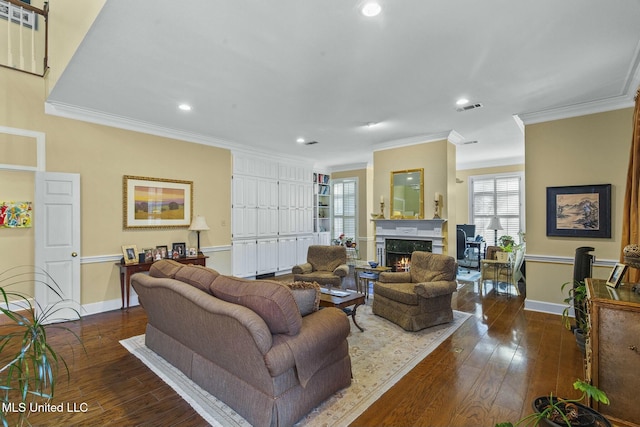 living room featuring a high end fireplace, dark wood-type flooring, and ornamental molding