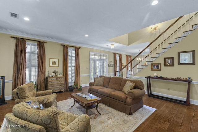 living room featuring dark hardwood / wood-style flooring and crown molding