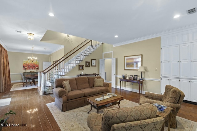 living room with crown molding, hardwood / wood-style floors, and a chandelier