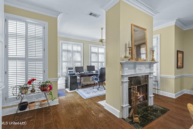 living room with a fireplace, dark wood-type flooring, ceiling fan, and crown molding