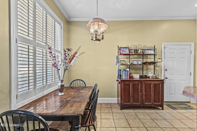 dining area featuring crown molding, light tile patterned floors, and an inviting chandelier