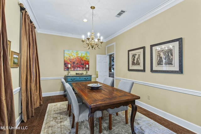 dining area featuring a chandelier, dark wood-type flooring, and ornamental molding