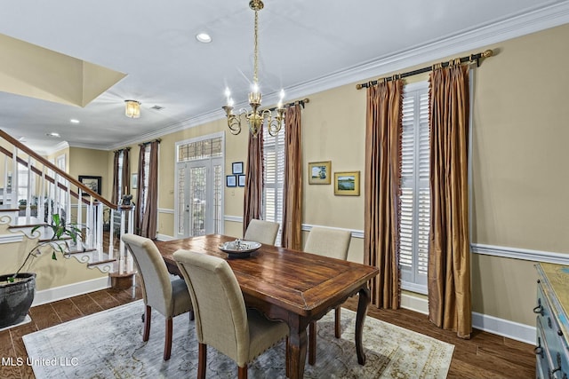 dining area featuring ornamental molding, plenty of natural light, and a notable chandelier