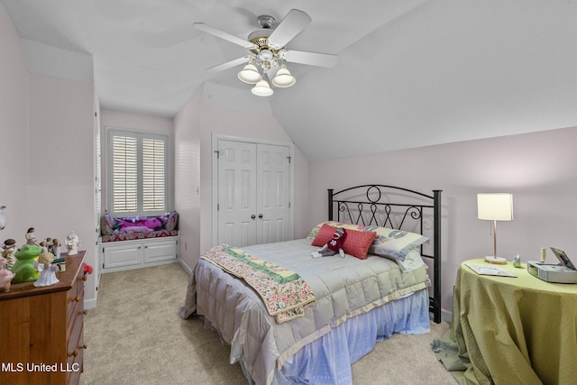 carpeted bedroom with ceiling fan, a closet, and lofted ceiling