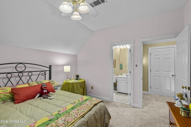 carpeted bedroom with ceiling fan, sink, ensuite bathroom, and vaulted ceiling