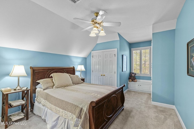 carpeted bedroom featuring a closet, ceiling fan, and lofted ceiling