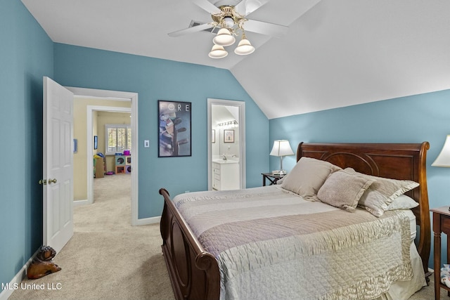 bedroom with ceiling fan, ensuite bathroom, vaulted ceiling, and light carpet