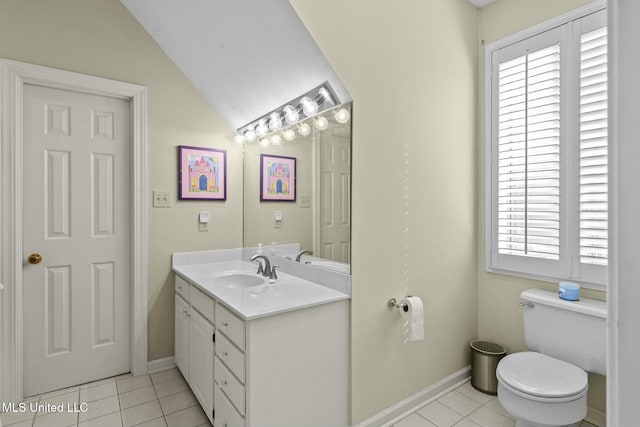 bathroom with toilet, vanity, tile patterned floors, and lofted ceiling