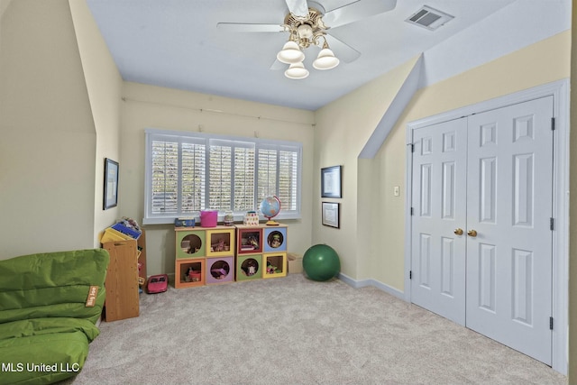 game room with ceiling fan and light colored carpet