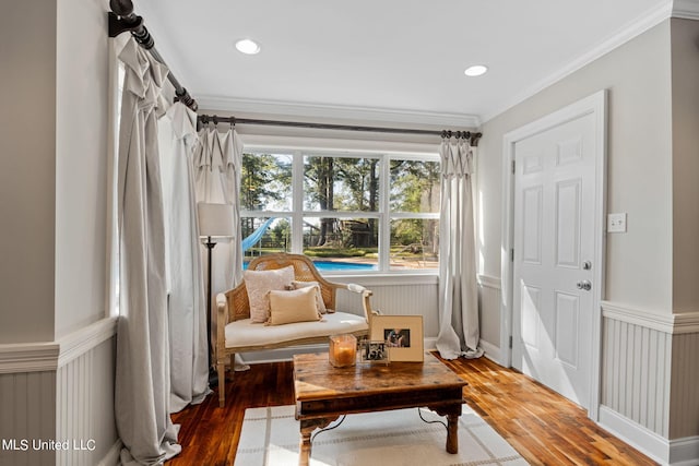 sitting room with crown molding and dark hardwood / wood-style flooring