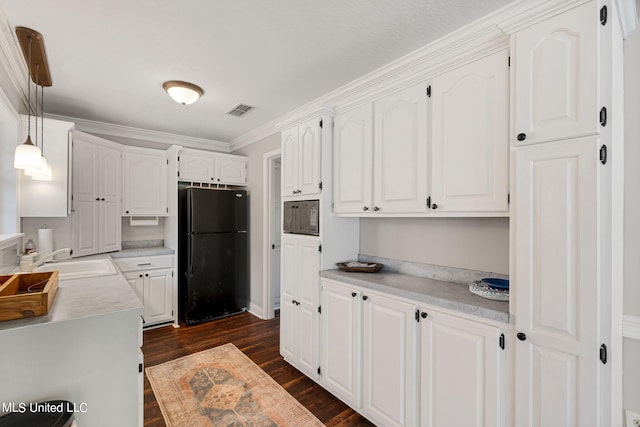 kitchen featuring white cabinetry, black appliances, and hanging light fixtures