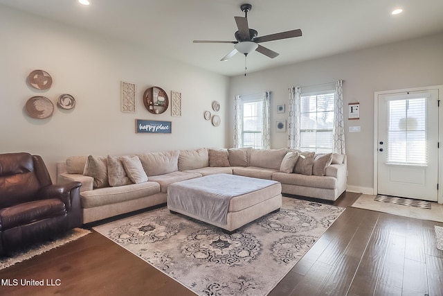 living room with dark hardwood / wood-style floors and ceiling fan