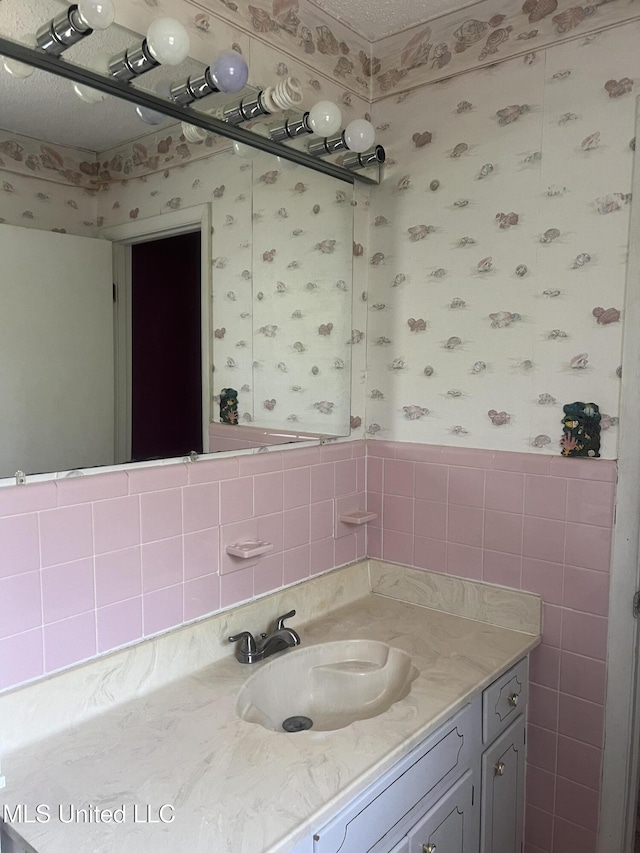 241 Iroquois St, Biloxi, MS 39530 - bathroom with wallpapered walls and vanity