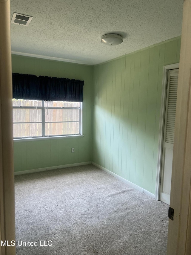 241 Iroquois St, Biloxi, MS 39530 - carpeted spare room with a textured ceiling