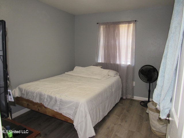 bedroom with hardwood / wood-style flooring