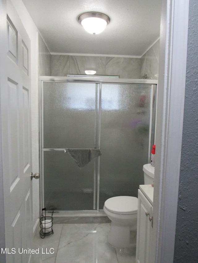 bathroom with toilet, an enclosed shower, and vanity