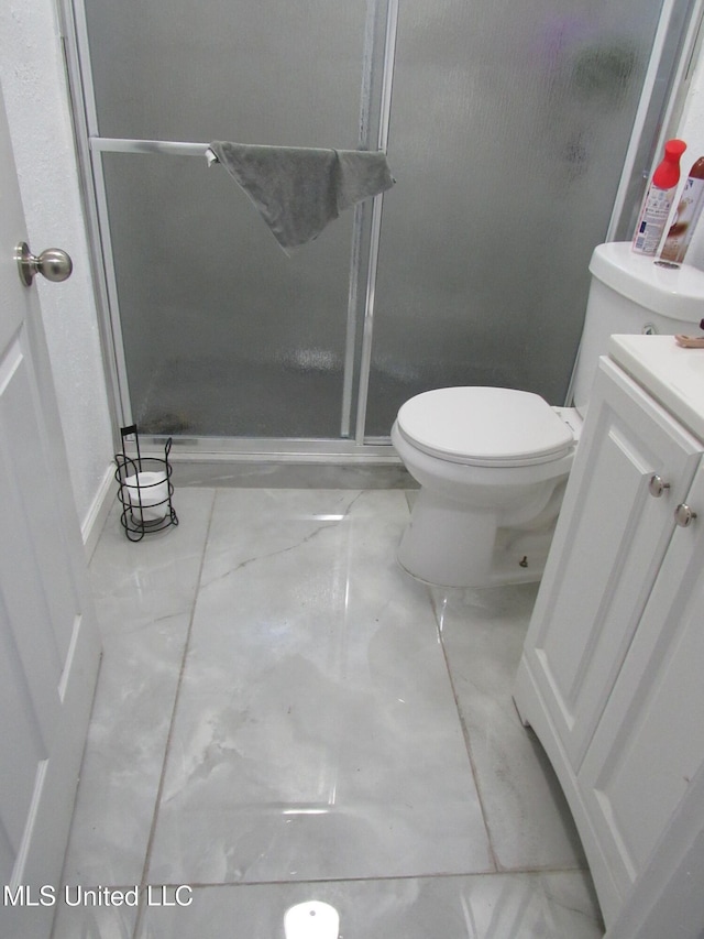 bathroom with vanity, a shower with shower door, and toilet