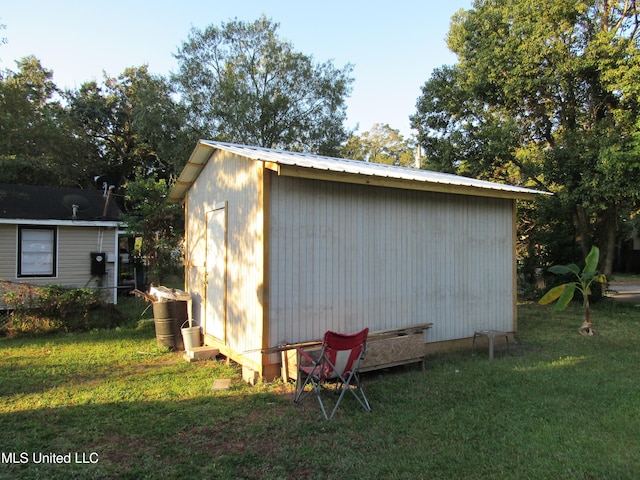 view of outbuilding featuring a lawn