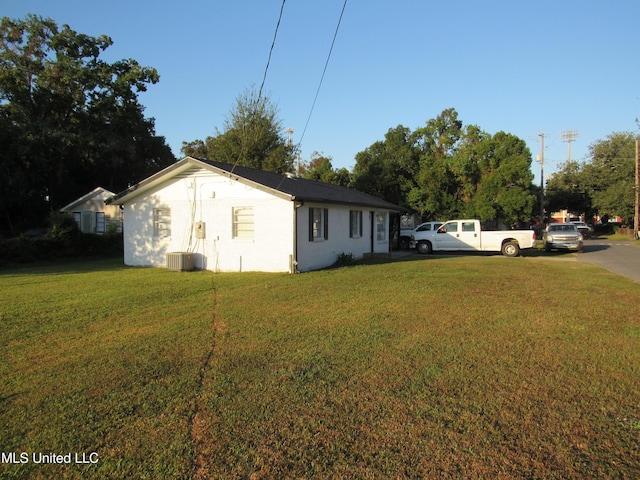 view of property exterior featuring a yard and central AC