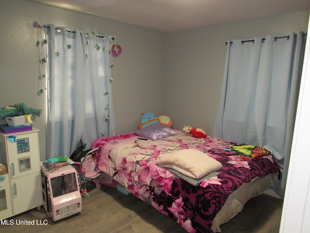 bedroom with wood-type flooring