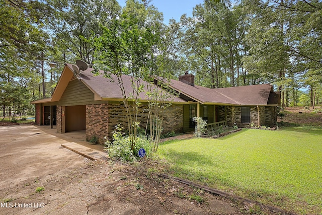 406 Springwood Cir, Terry, MS 39170 - view of front of property with concrete driveway, a front yard, a chimney, and brick siding