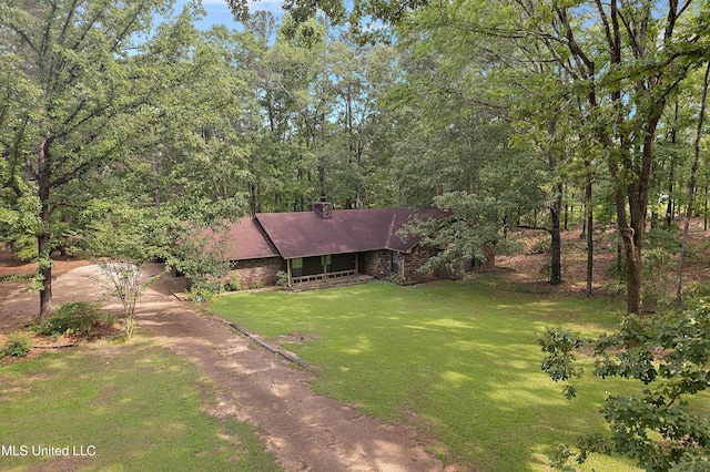 406 Springwood Cir, Terry, MS 39170 - view of front of property with a front yard, a shingled roof, brick siding, and a chimney