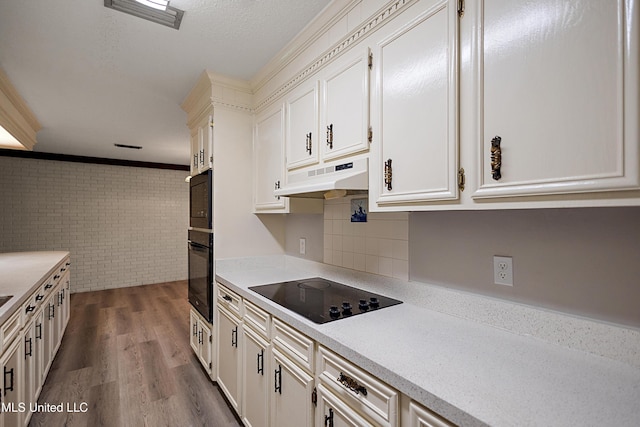 406 Springwood Cir, Terry, MS 39170 - kitchen featuring black appliances, under cabinet range hood, dark wood finished floors, white cabinets, and crown molding