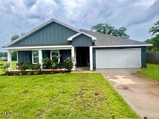 154 Magnolia Farms Dr, Lucedale, MS 39452 - view of front of home with a garage, concrete driveway, and a front yard