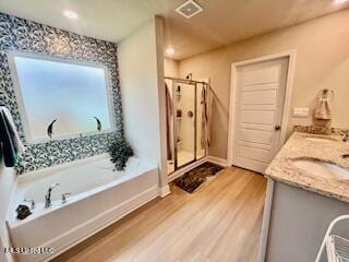 154 Magnolia Farms Dr, Lucedale, MS 39452 - full bathroom with wood finished floors, a bath, a shower stall, double vanity, and recessed lighting