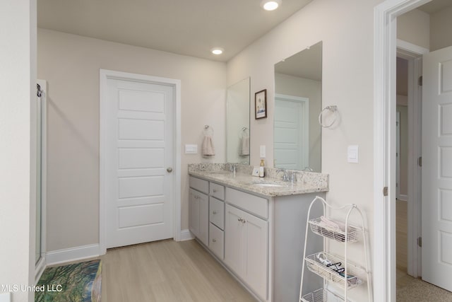 154 Magnolia Farms Dr, Lucedale, MS 39452 - full bathroom featuring double vanity, wood finished floors, recessed lighting, and baseboards