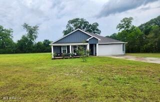 154 Magnolia Farms Dr, Lucedale, MS 39452 - view of front facade with a front yard, a garage, and driveway