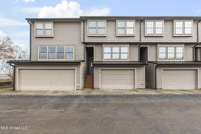 multi unit property featuring a garage