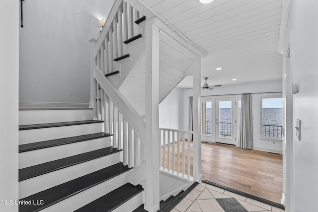 staircase with french doors, tile patterned floors, and ceiling fan