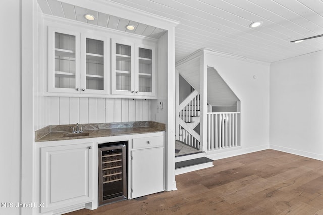 bar featuring sink, white cabinetry, dark hardwood / wood-style flooring, wood ceiling, and wine cooler