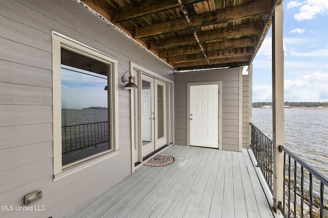 wooden terrace featuring a water view